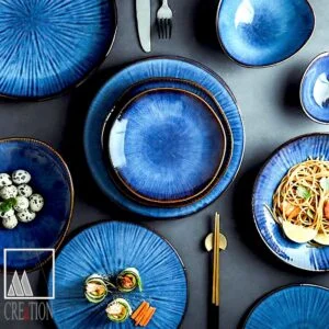 Bring sophistication to your dining table with the Midnight Medley Tunisian Varnished Ceramic Plate. Made with care in the M'Creations workshop in Nabeul, this luxurious high-quality plate is a true work of art. The deep, dark blue ceramic finish is hand-painted with attention to detail, showcasing the traditional Tunisian hand work.